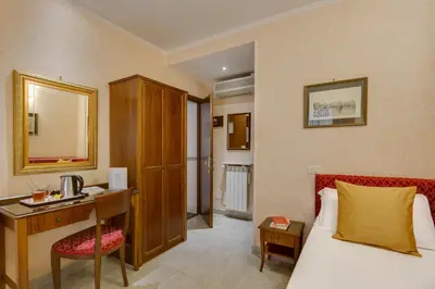 a hotel room with a bed and a desk and a bed and a desk at Hotel Silla in Rome