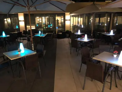 a restaurant with white tables and black chairs at Cardinal Hotel St. Peter in Rome