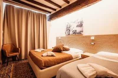 a hotel room with two beds and a window at Hotel Domus Tiberina in Rome