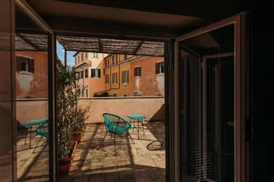 a view of a balcony with chairs and a table at Hotel Domus Tiberina in Rome
