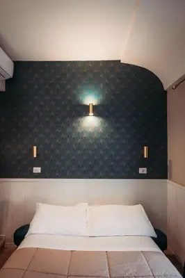 a bedroom with a bed with a black wall at Hotel Domus Tiberina in Rome