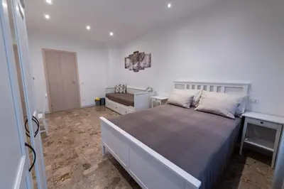 a bedroom with a large bed and a sink at Casa Rosa Beige e Blu in Rome