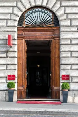 an entrance to a building with a wooden door at Hotel Giolli Nazionale in Rome