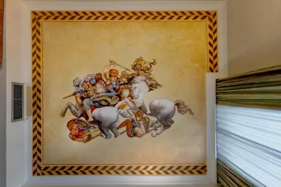 a painting of a group of men riding horses at Hotel Amalfi in Rome