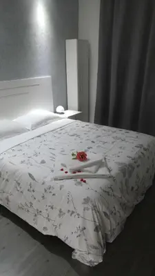 a bedroom with a white bed with flowers on it at Arts & Rooms in Rome