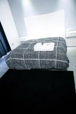 a black and white bed in a room at Arts & Rooms in Rome