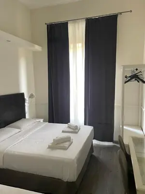 a bedroom with a white bed and a window at Arts & Rooms in Rome