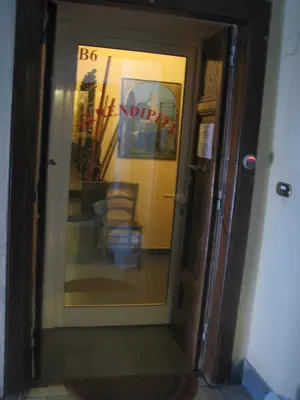 a glass door of a building with a chair behind it at Serendipity in Rome
