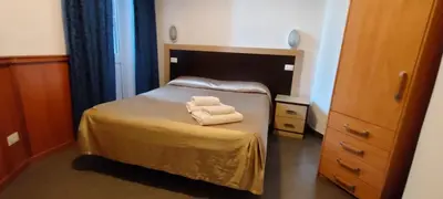 a bedroom with a bed with two towels on it at Serendipity in Rome