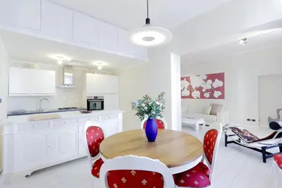 a kitchen and living room with a wooden table and chairs at RomeAsYouLike-Colosseo Experience45 in Rome