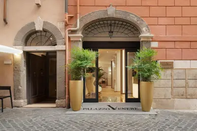 a bedroom with a large white bed with a large headboard at Palazzo Venere in Rome