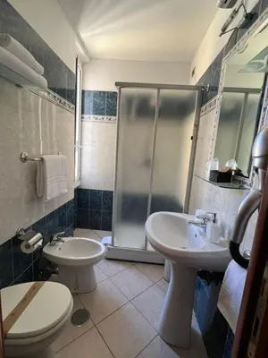 a bathroom with two sinks and a shower at Città Eterna Guest House in Rome