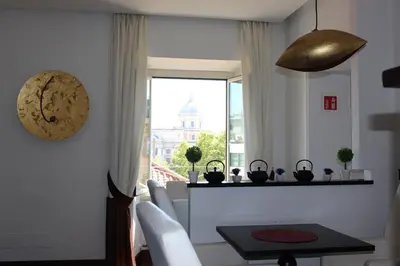 a dining room with a table and a window at Relais La Maison De Luxe in Rome