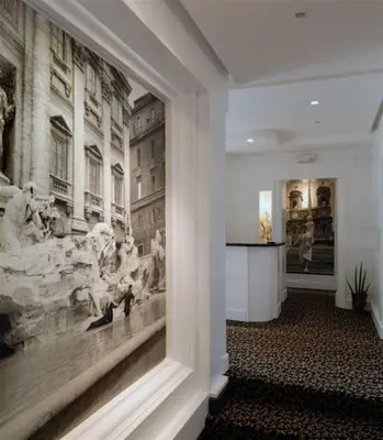a hallway with a large painting on the wall at Relais La Maison De Luxe in Rome