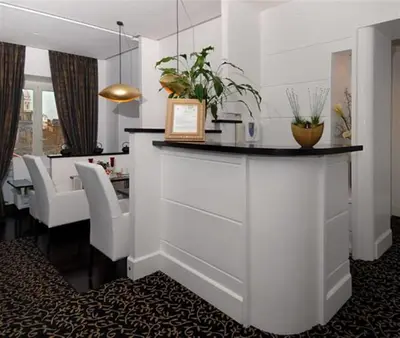 a dining room with a counter and a dining table at Relais La Maison De Luxe in Rome