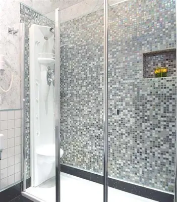 a shower with a glass door in a bathroom at Relais La Maison De Luxe in Rome