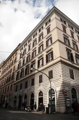 a large building on the corner of a street at Relais La Maison De Luxe in Rome