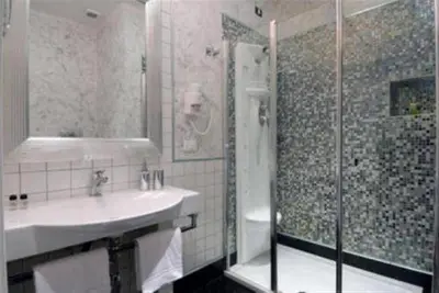a bathroom with a sink and a shower at Relais La Maison De Luxe in Rome