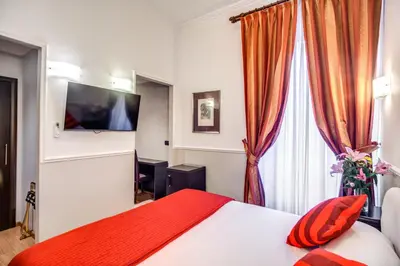 a hotel room with a bed and a flat screen tv at Hotel Everest Inn Rome in Rome