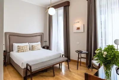 a hotel room with a bed and a window at Relais Rione Ponte in Rome