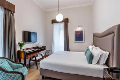 a hotel room with a bed and a desk at Relais Rione Ponte in Rome