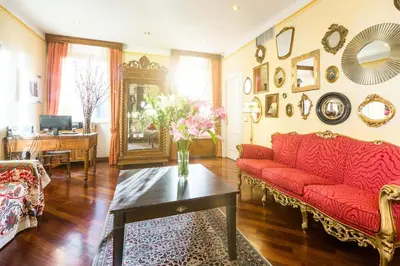 a living room with a red couch and a table at Casa De' Fiori in Rome