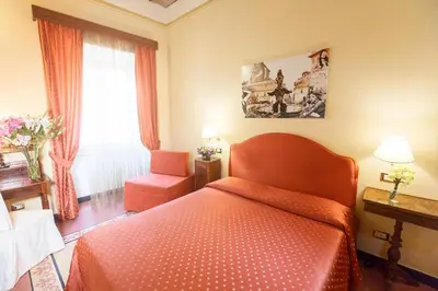 a bedroom with a red bed and a window at Casa De' Fiori in Rome
