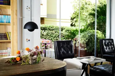 a dining room with a table with flowers on it at Hotel Pulitzer in Rome