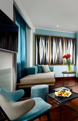 a living room with a bed and a table at Hotel Pulitzer in Rome