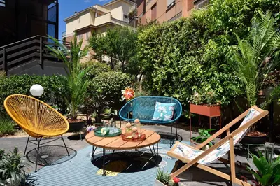 a patio with chairs and a table and a table and chairs at Hotel Pulitzer in Rome