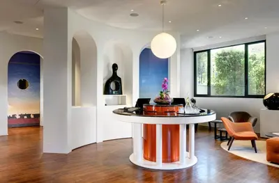 a living room with a table in the middle of a room at Hotel Pulitzer in Rome