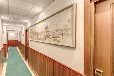 a hallway with a painting on the wall at Hotel Flavio in Rome