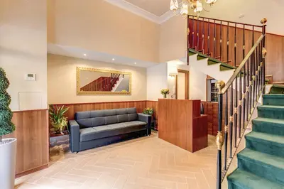a living room with a couch and stairs at Hotel Flavio in Rome