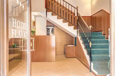 a lobby with stairs and a sign that reads hotel elrak at Hotel Flavio in Rome