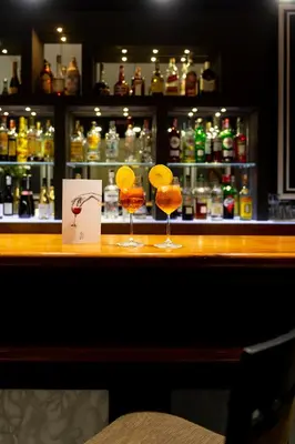 a bar with two cocktails sitting on a counter at Hotel Principe Torlonia in Rome