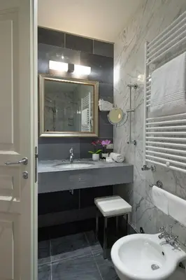 a bathroom with a sink and a mirror at Hotel Principe Torlonia in Rome