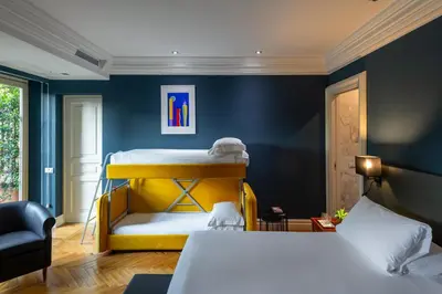 a bedroom with a bed and a blue wall at Hotel Principe Torlonia in Rome