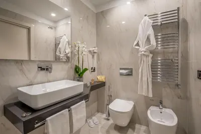 a white bathroom with a sink and a toilet at Hotel Gioberti in Rome