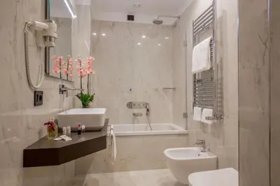a bathroom with a sink and a toilet and a tub at Hotel Gioberti in Rome