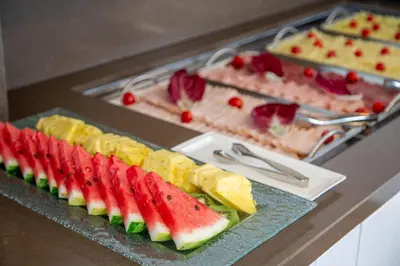 a buffet with fruits and vegetables on a table at Hotel Gioberti in Rome