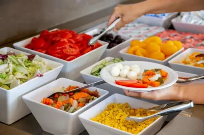 a person holding a bowl of vegetables and fruits at Hotel Gioberti in Rome