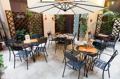 a restaurant with tables and chairs and an umbrella at Hotel Genova in Rome