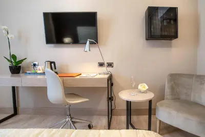 a room with a desk and a chair and a tv at Hotel Genova in Rome