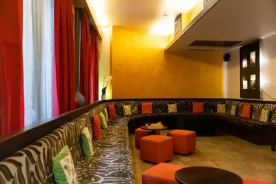 a restaurant with orange and black seats and a table at Hotel Re Di Roma in Rome