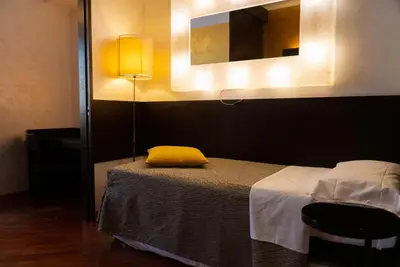a bedroom with a bed with a yellow pillow on it at Hotel Re Di Roma in Rome