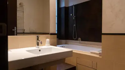 a bathroom with a sink and a bath tub at Hotel Re Di Roma in Rome