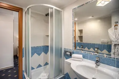 a bathroom with a sink and a shower at Hotel Napoleon in Rome