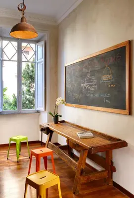 a dining room with a wooden table and two chairs at San Pietro Boutique Rooms in Rome