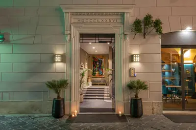 an entrance to a building with a doorway with plants at Condotti Boutique Hotel in Rome