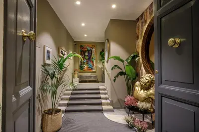 a hallway with plants and a door at Condotti Boutique Hotel in Rome